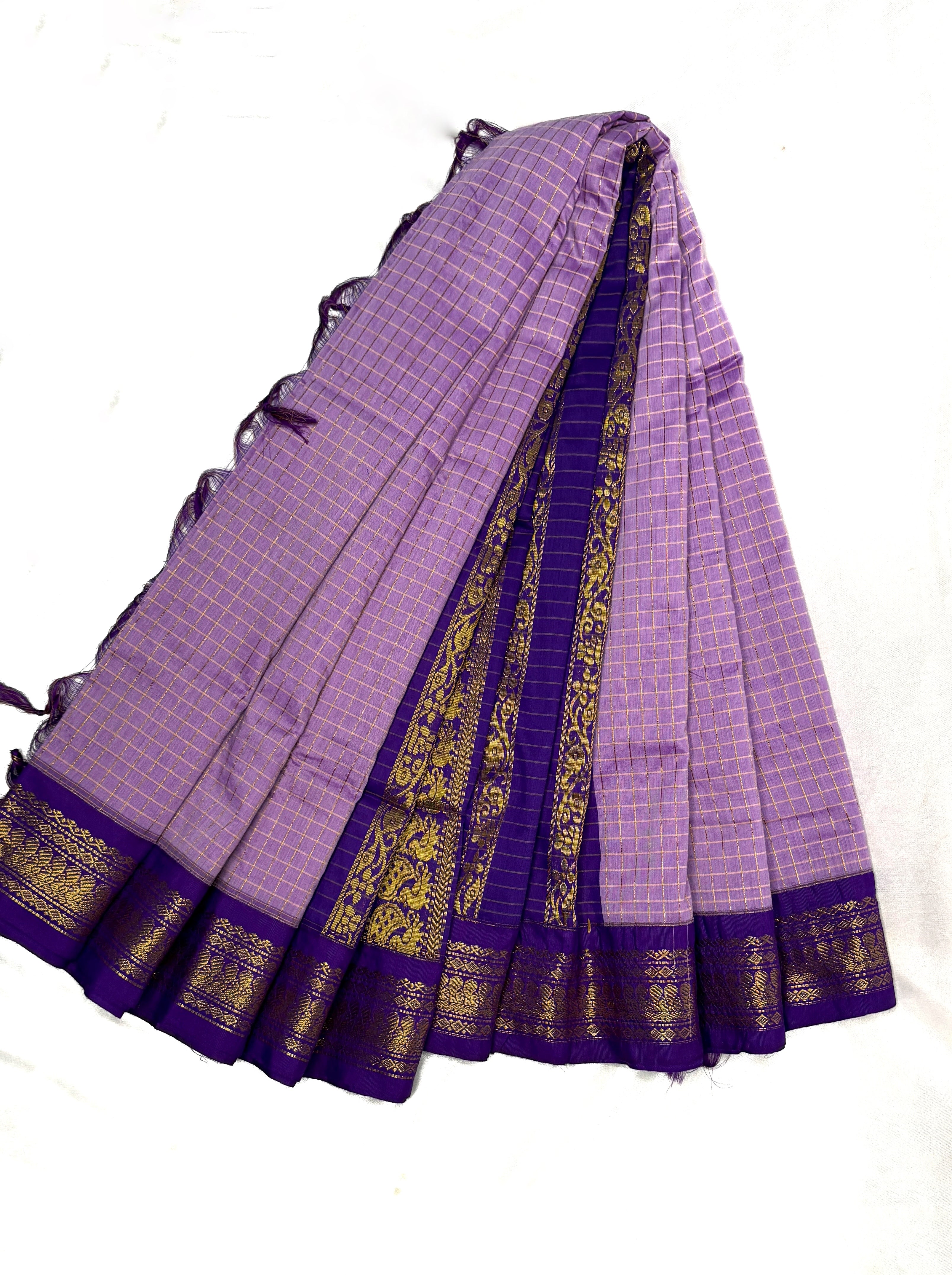 Lavender saree with gold border on a white background