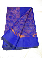  Blue saree with kolam patterns on a white background