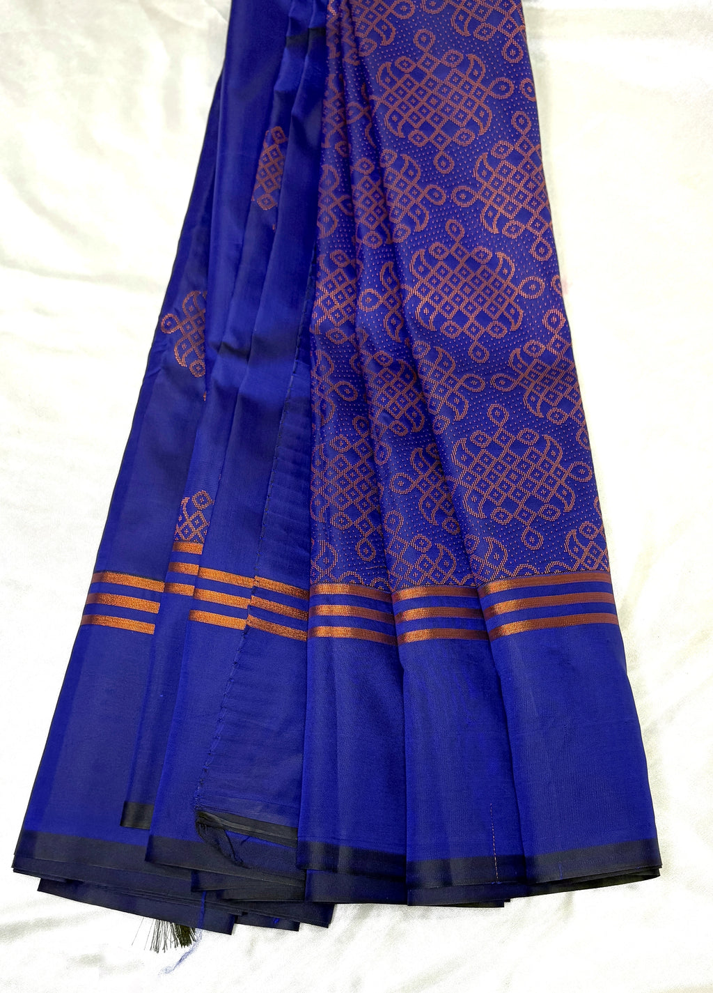 Blue saree with kolam fleet  patterns on a white background