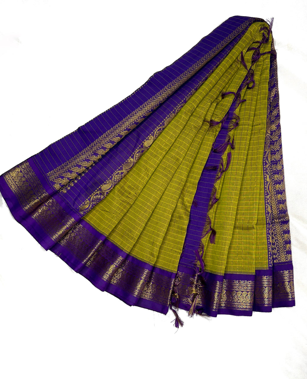 Green and purple saree with gold border on a white background