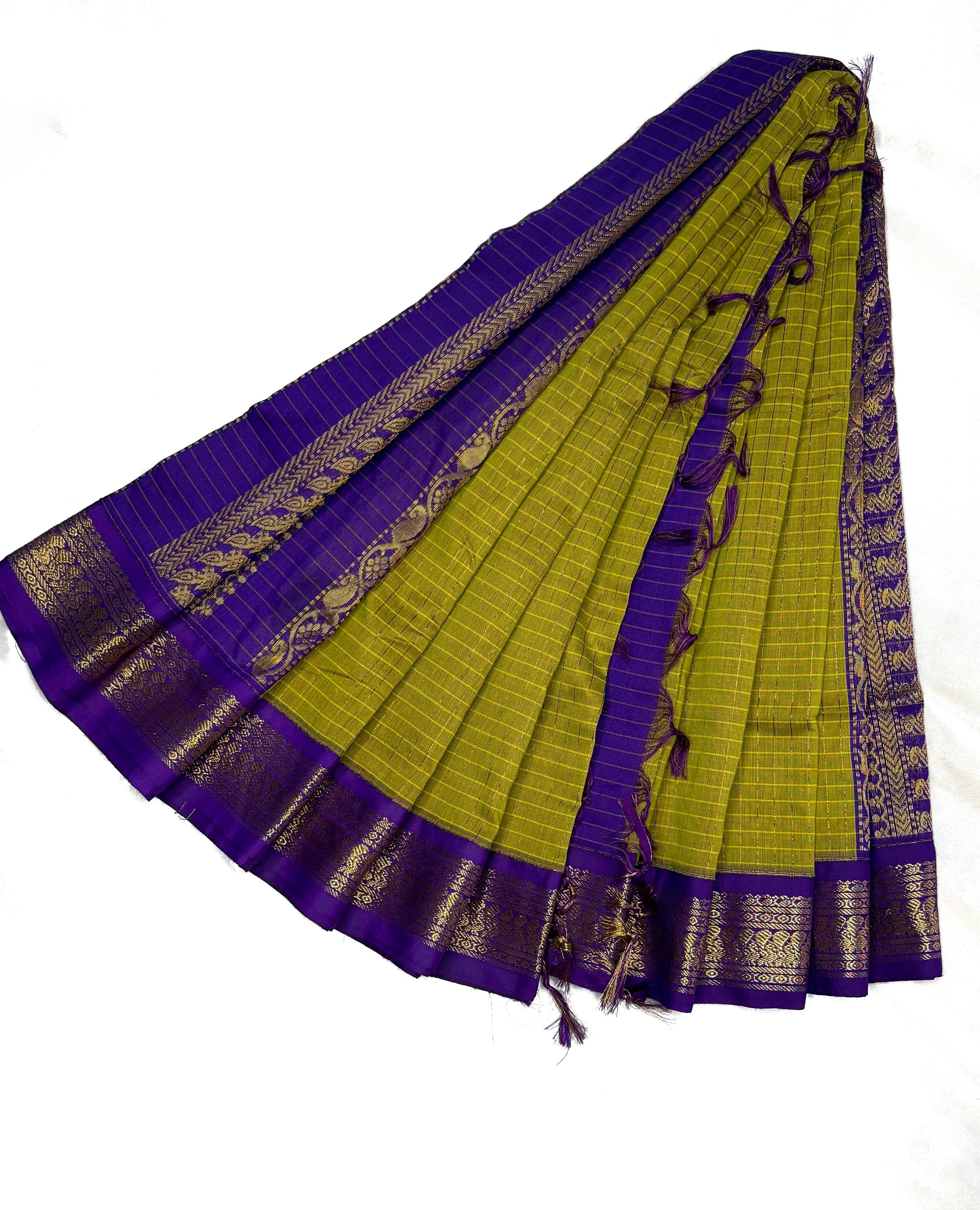 Green and purple saree with gold border on a white background