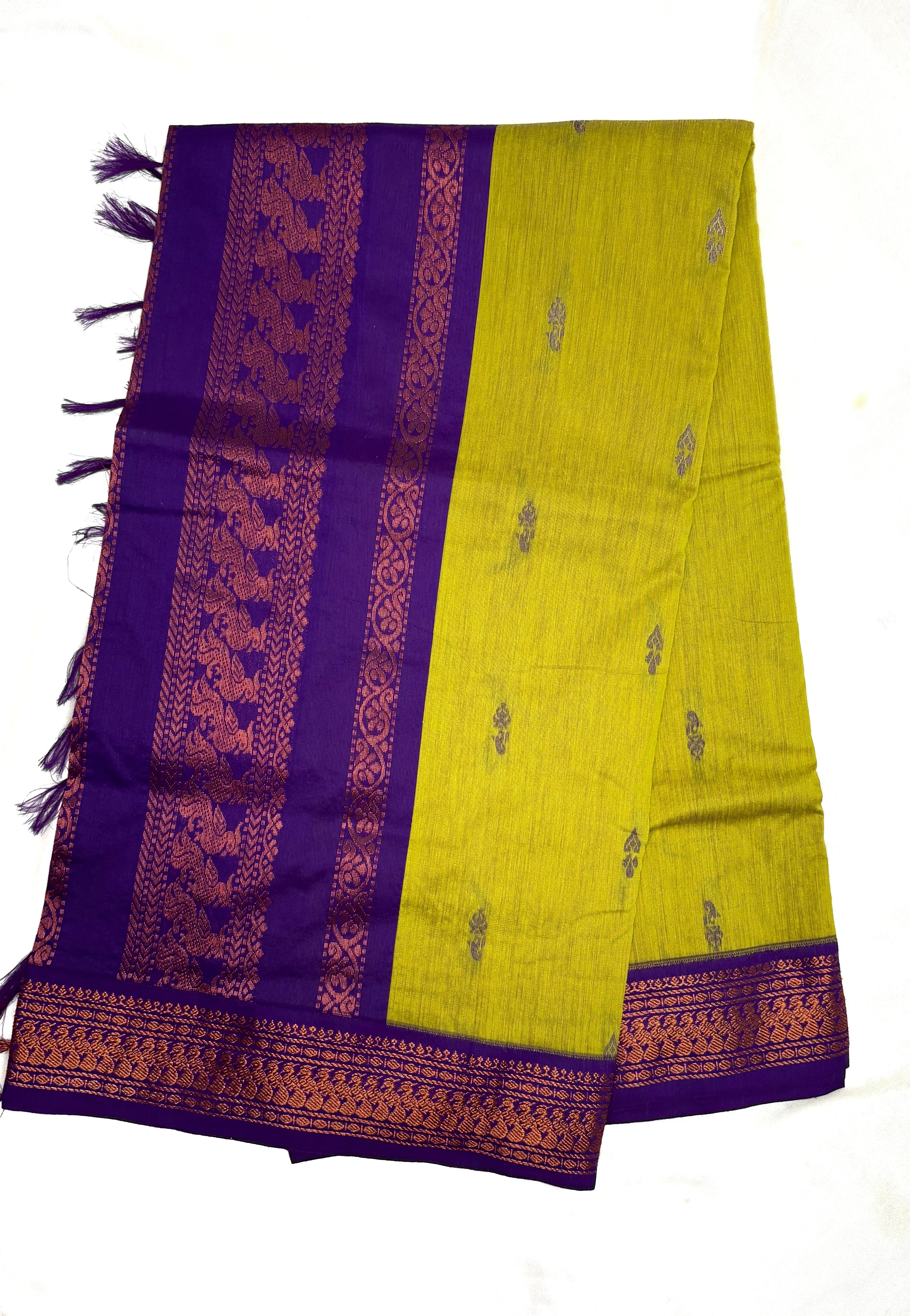 Shop lemon green Kalyani cotton saree with purple peacock zari border. Lightweight South Indian cotton saree perfect for daily wear and festive occasions.
