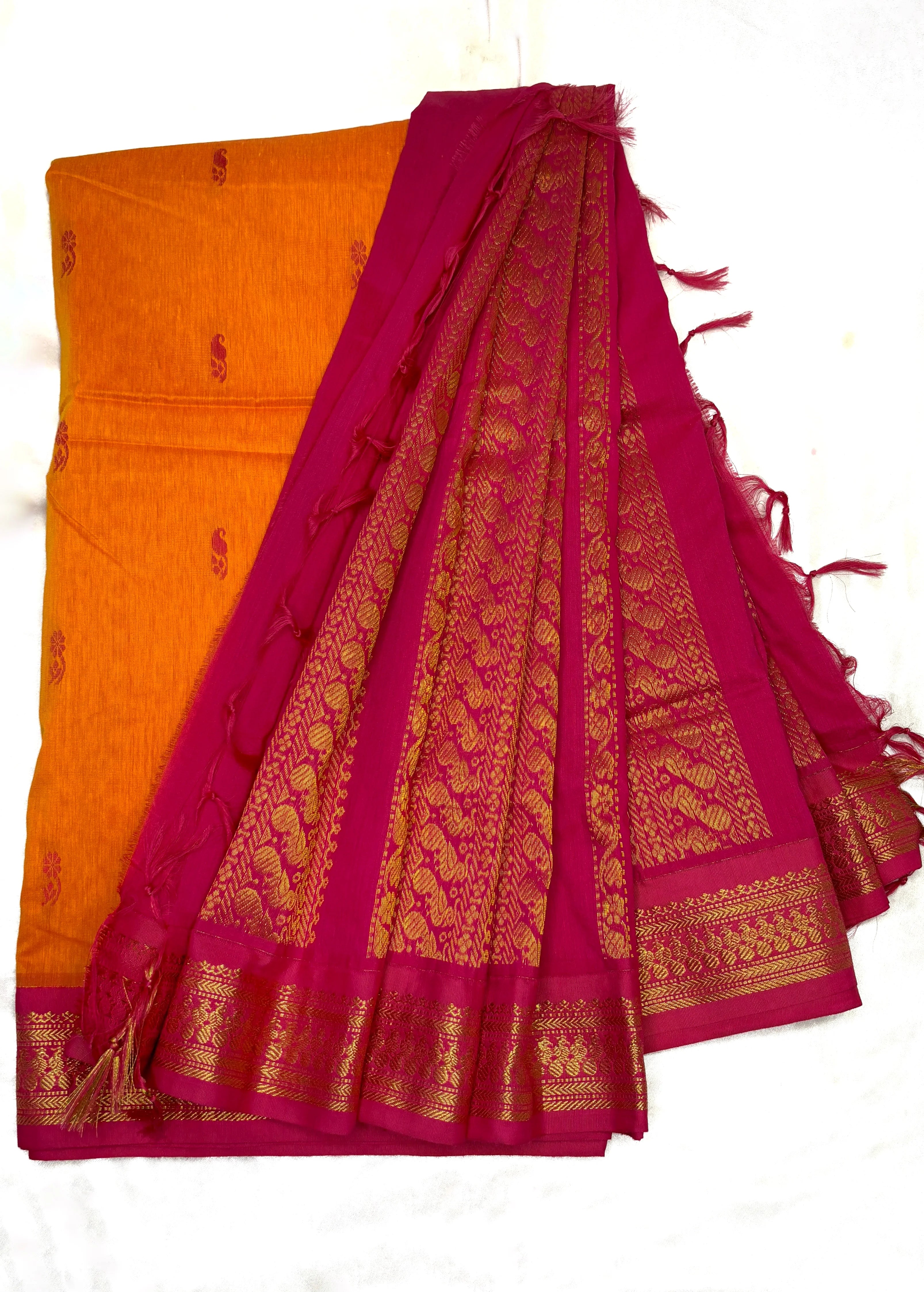 Orange saree with a pink border on a white background