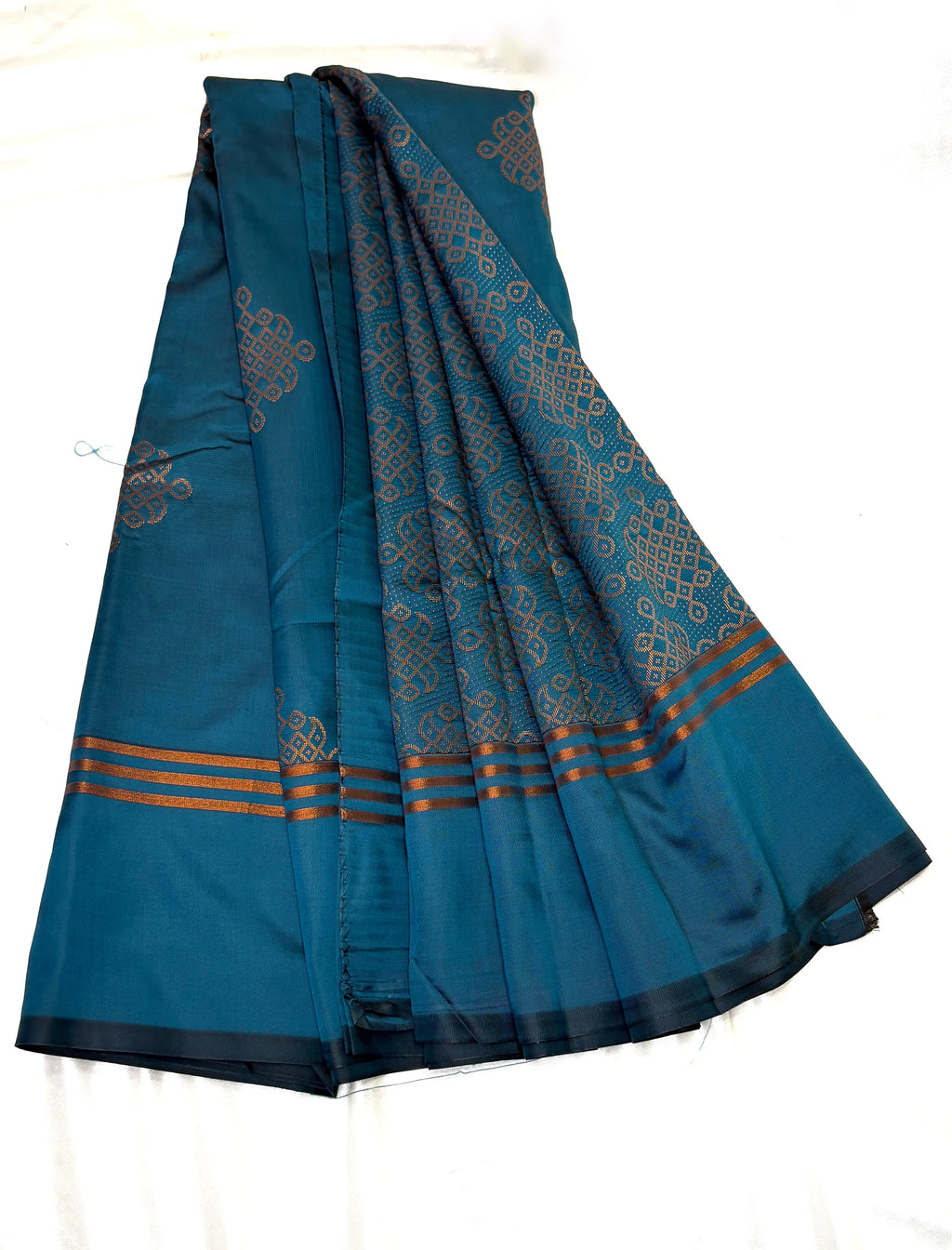 Blue saree with intricate patterns on a white background