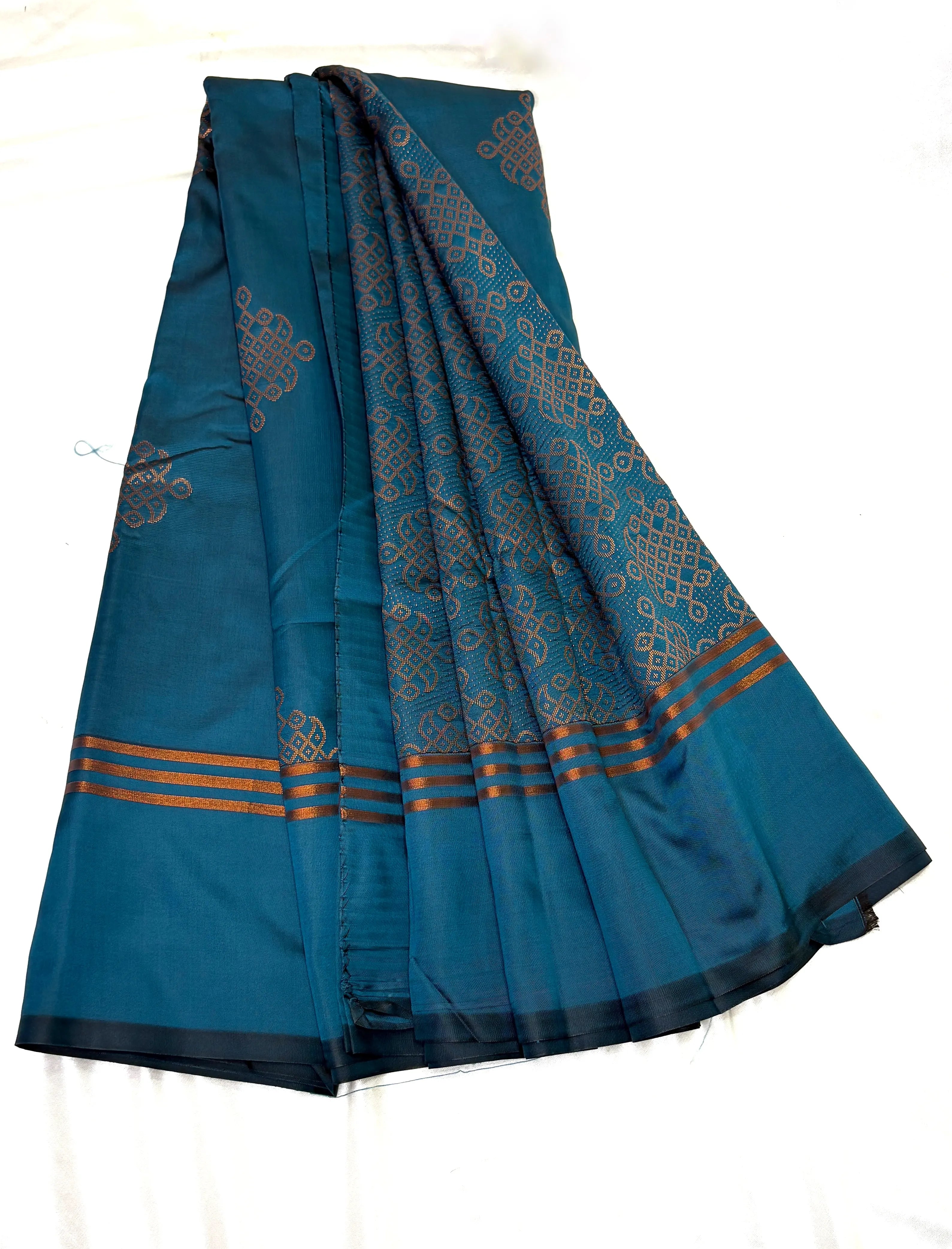 Blue saree with intricate patterns on a white background