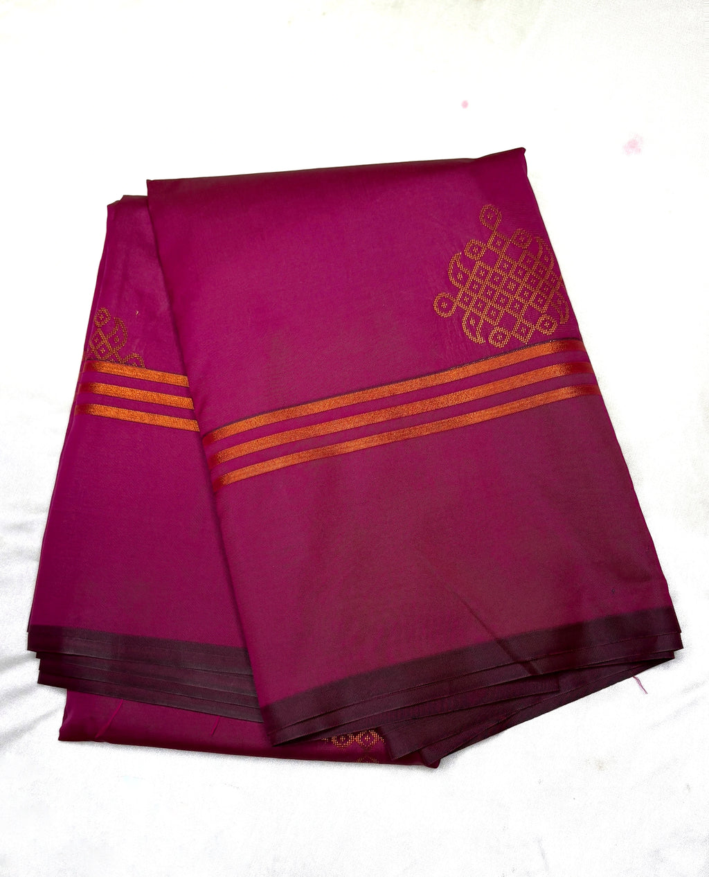 Purple fabric with gold patterns on a white background