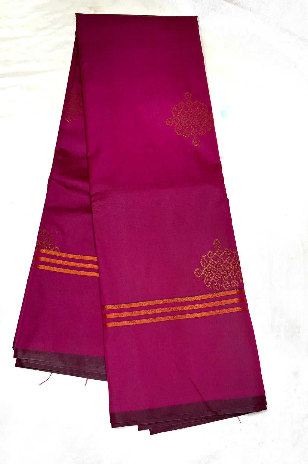 Purple saree with gold patterns with kolam on a white background